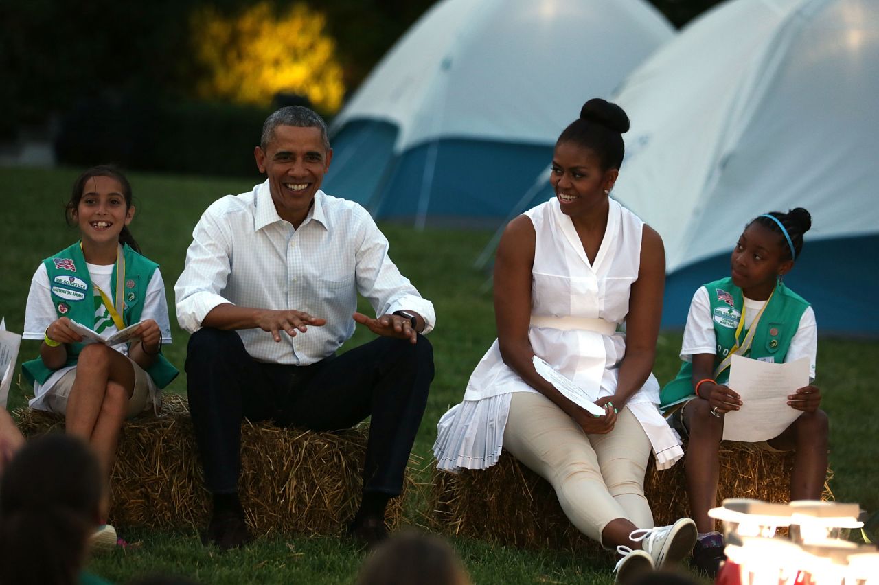 Obama and first lady Michelle Obama talk with Girl Scouts who camped on the South Lawn of the White House on Tuesday, June 30.