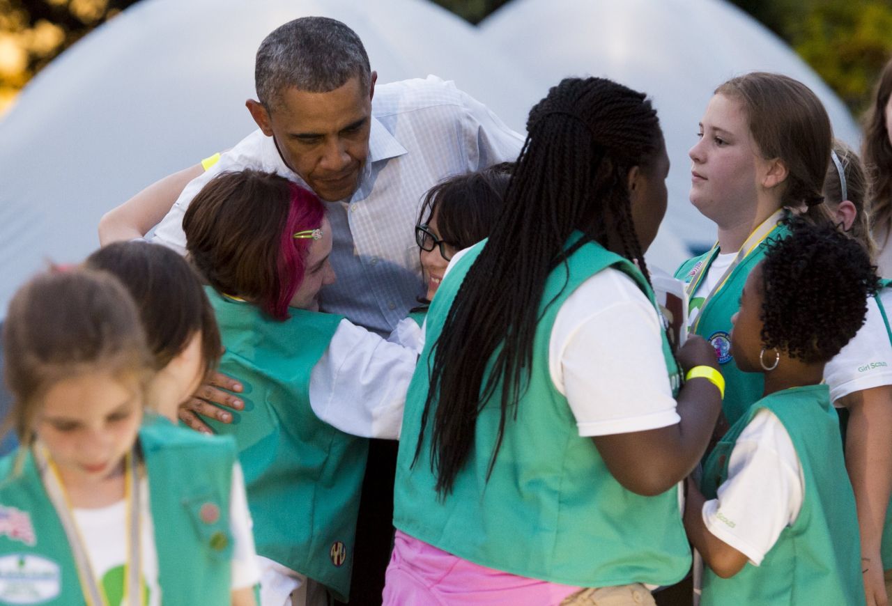As the President got ready to leave for the night, he told the Girl Scouts "You guys are having so much fun, but unfortunately, I've got to go to work." Some Girl Scouts were not pleased, but Obama quickly added "but we can have a group hug," and all 50 Scouts swarmed around him.
