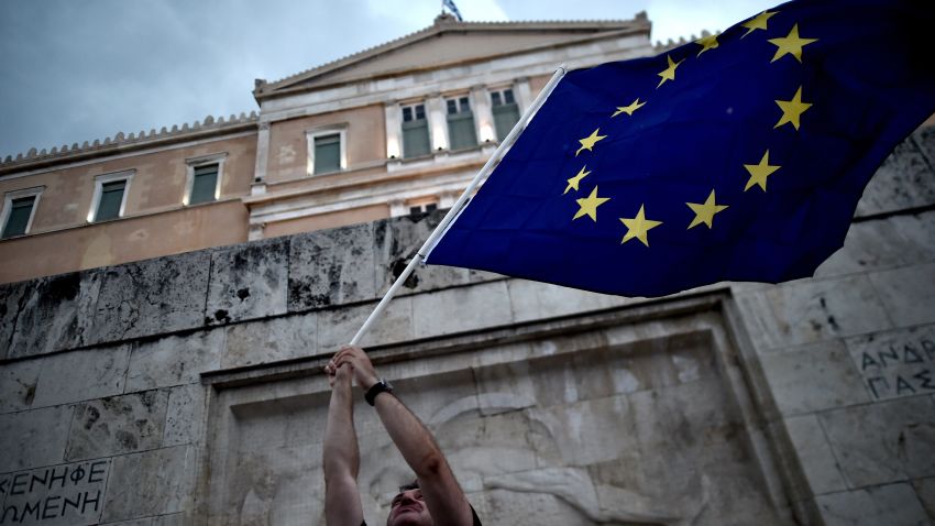 A pro-European Union protester waves an EU flag during a demonstration in front of the parliament in Athens on June 30, 2015. 2015.   Thousands of people rallied in Athens in support of a bailout deal with international creditors which has been rejected by Prime Minister Alexis Tsipras, leaving Greece on the brink of default.  AFP PHOTO / ARIS MESSINIS        (Photo credit should read ARIS MESSINIS/AFP/Getty Images)