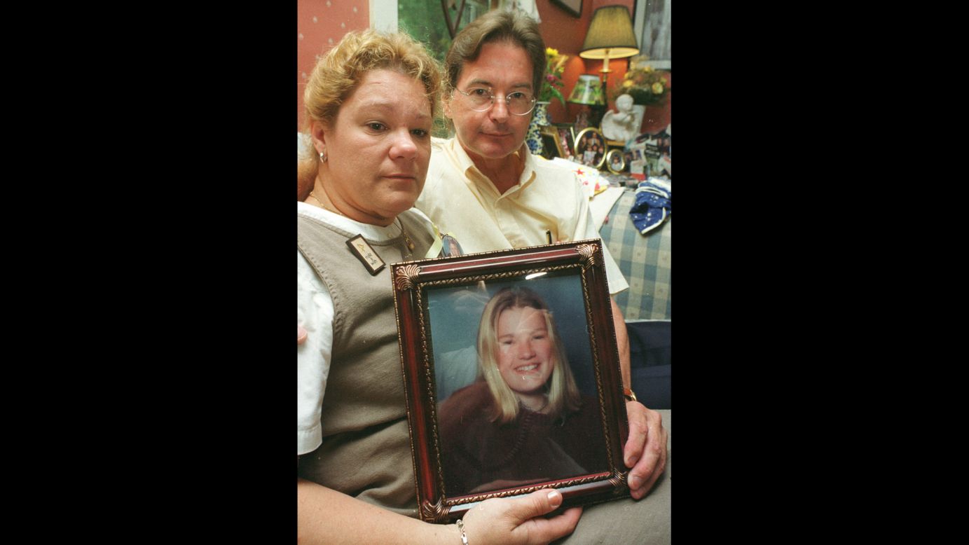 The parents of Molly Bish hold a photo of their daughter. Bish's mother dropped her off for work in June 2000. Molly was never seen alive again. The lifeguard's remains were recovered three years later.
