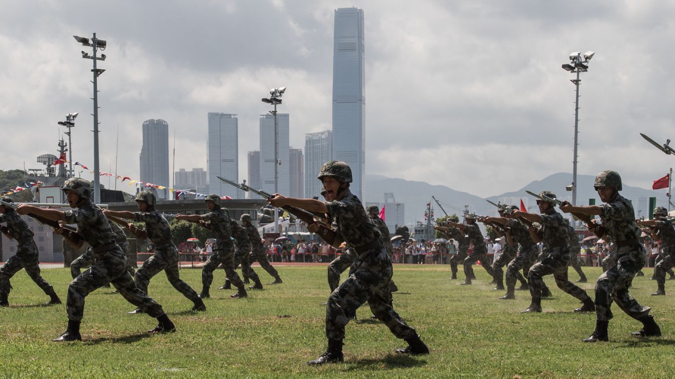 Soldiers perform a drill not far from the International Commerce Center (ICC), the city's tallest skyscraper.