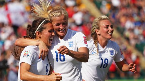England's Katie Chapman, center, congratulates Fara Williams after Williams tied the score on a penalty kick. Both teams traded penalty-kick goals before Bassett's own goal.