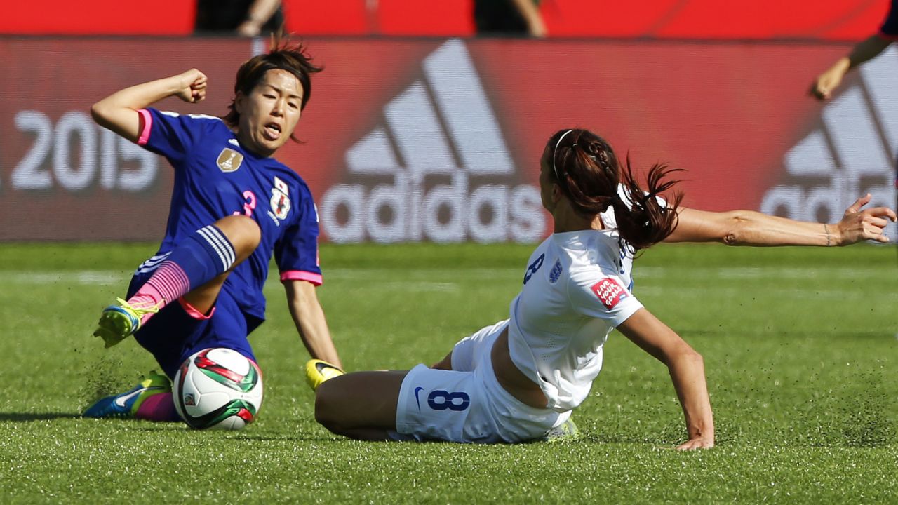 Jill Scott of England and Azusa Iwashimizu of Japan slide in for the ball.