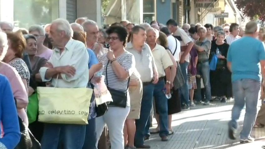Greek pensioners wait in line on Thursday, July 2, 2015 in Athens, Greece