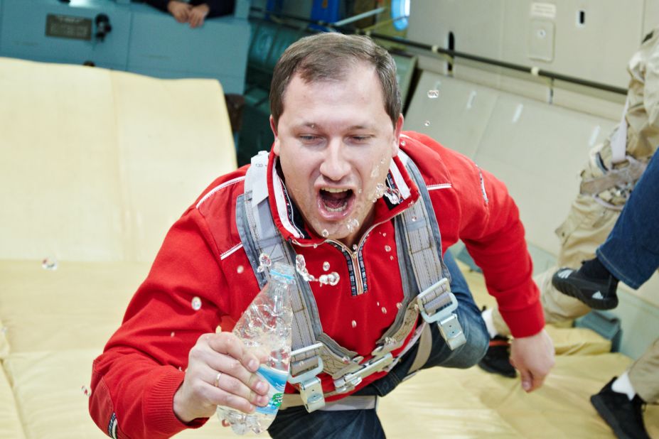 Drinking from a bottle of water is no easy task at the center's zero-gravity laboratory.