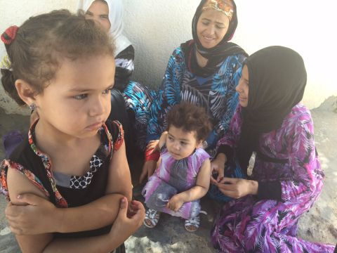 Women and children gather in Al Zuhour district in Kasserine.