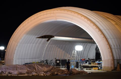 A mobile hangar is opened on Tuesday, June 23, as the plane is prepared for a possible takeoff.  The plane had been waiting in Japan for three weeks because of bad weather. 