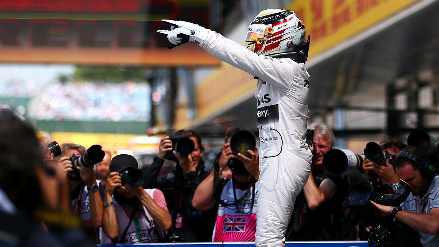 Lewis Hamilton celebrates in parc ferme after claiming pole at the British Grand Prix at Silverstone.