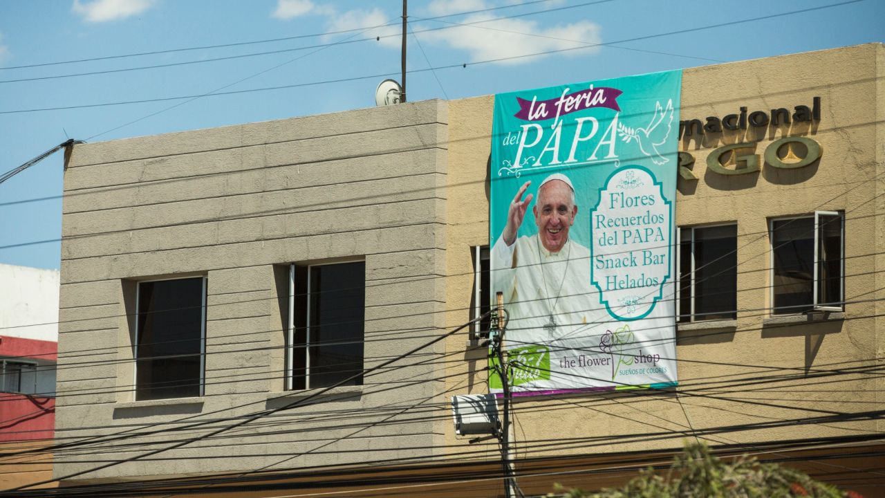 Signs welcoming Pope Francis are on many street corners in Quito, where he begins his visit to Ecuador on Sunday, July 5. This sign uses the Pope's images to draw attention to a flower shop in downtown Quito. 