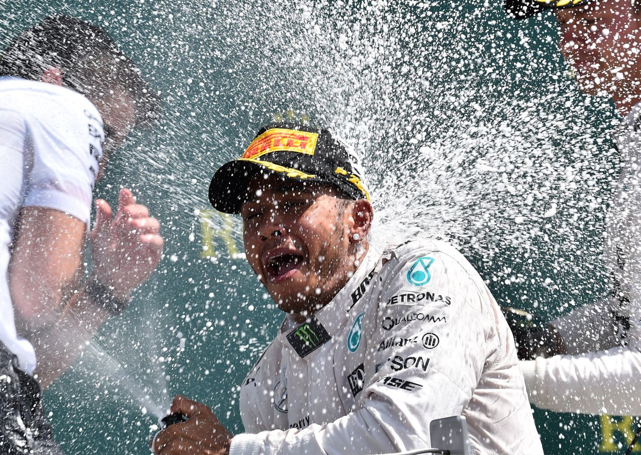 Lewis Hamilton sprays the bubbly after his battling victory at the British Grand Prix to extend his title lead over teammate  Nico Rosberg.