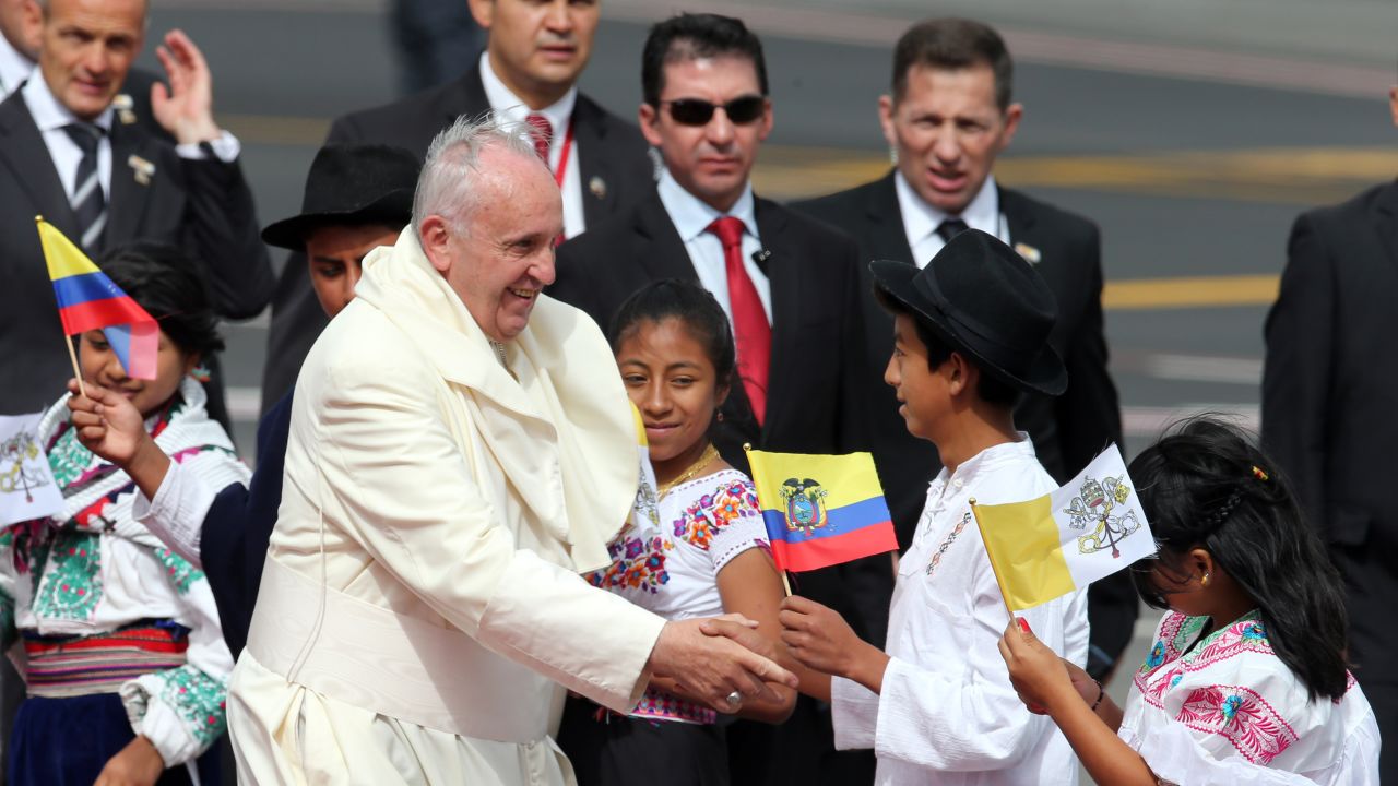 Pope Francis greets several children upon his arrival to the Mariscal Sucre International airport in Quito Sunday.