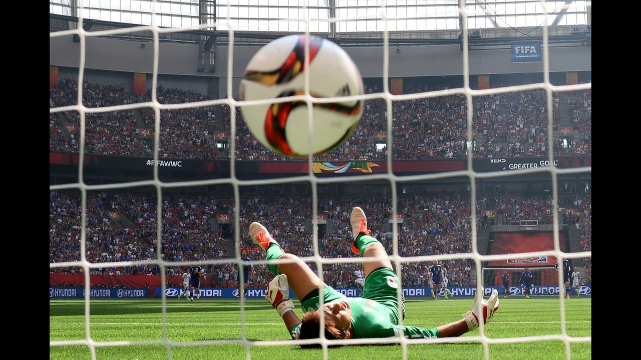 Ayumi Kaihori of Japan reacts as a ball from Carli Lloyd rolls into the goal box.