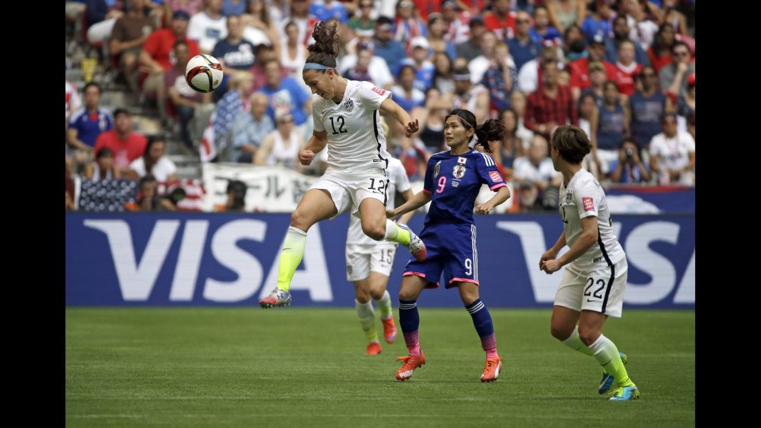 Lauren Holiday of the United States heads the ball above Japan's Nahomi Kawasumi.