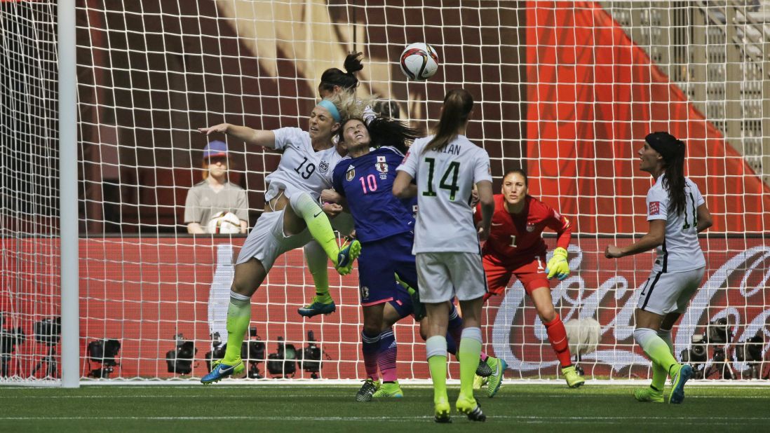 U.S. goalkeeper Hope Solo watches as American Julie Johnston and Homare Sawa of Japan battle for a header during the second half.