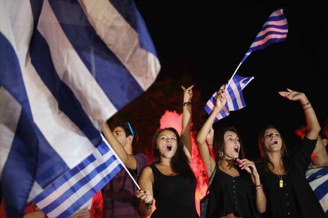 People celebrate in front of the Greek parliament in Athens on Monday after voters rejected a debt bailout by creditors.