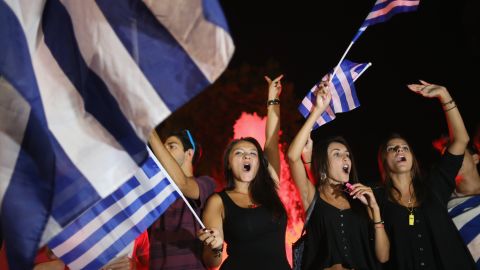 People celebrate in front of the Greek parliament in Athens on July 6 after voters rejected a debt bailout by creditors.