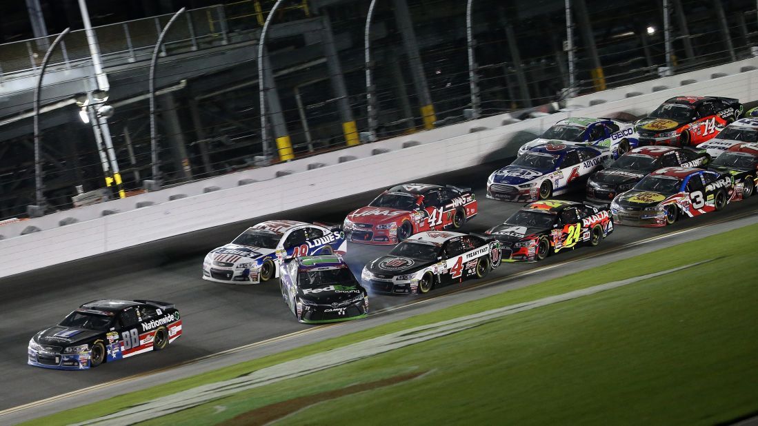 Dale Earnhardt Jr. in the No. 88 Chevrolet crosses the finish line to win as Denny Hamlin in the No. 11 Toyota, begins to lose control and spins.