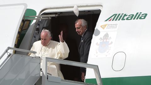 A gust of wind blows off Pope Francis' skullcap upon his arrival at the Mariscal Sucre International Airport in Quito on July 5.