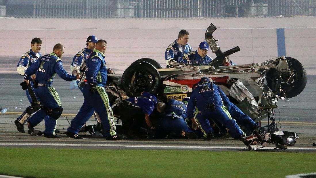 Crew members rush to check on Dillon after his car stopped rolling.