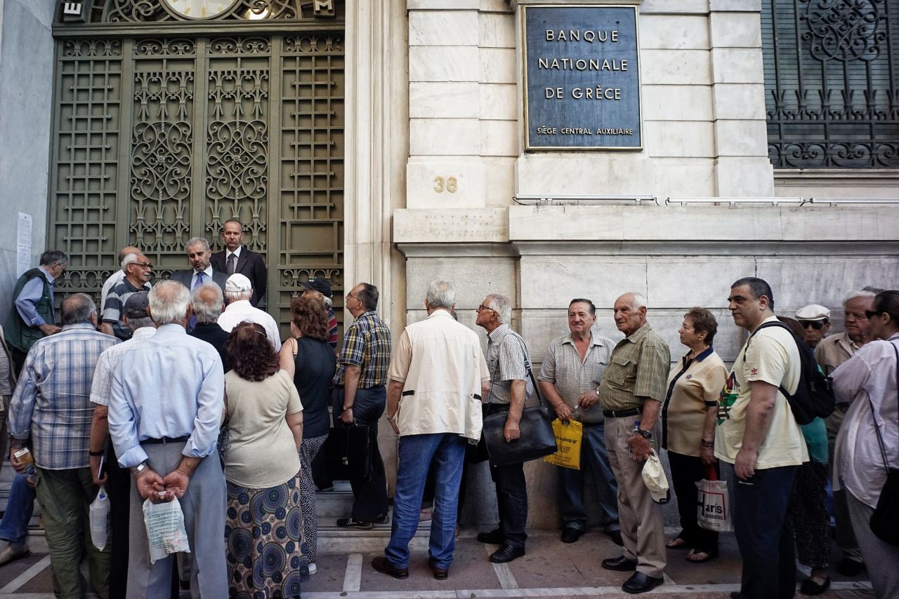 Pensioners line up outside a National Bank branch on Thursday, July 2, 2015 in Athens. 
