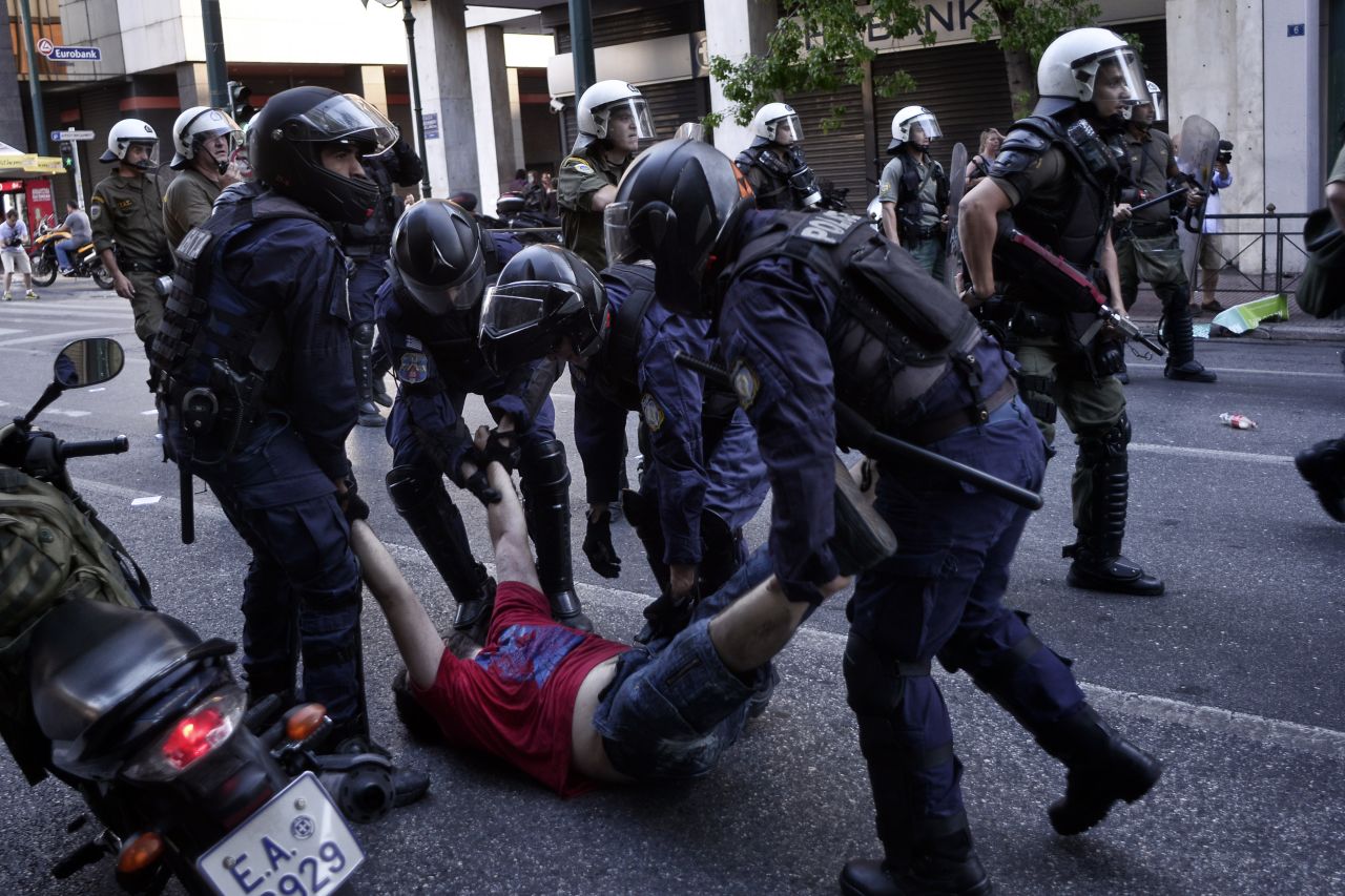 A demonstrator is arrested during an anti-austerity rally.