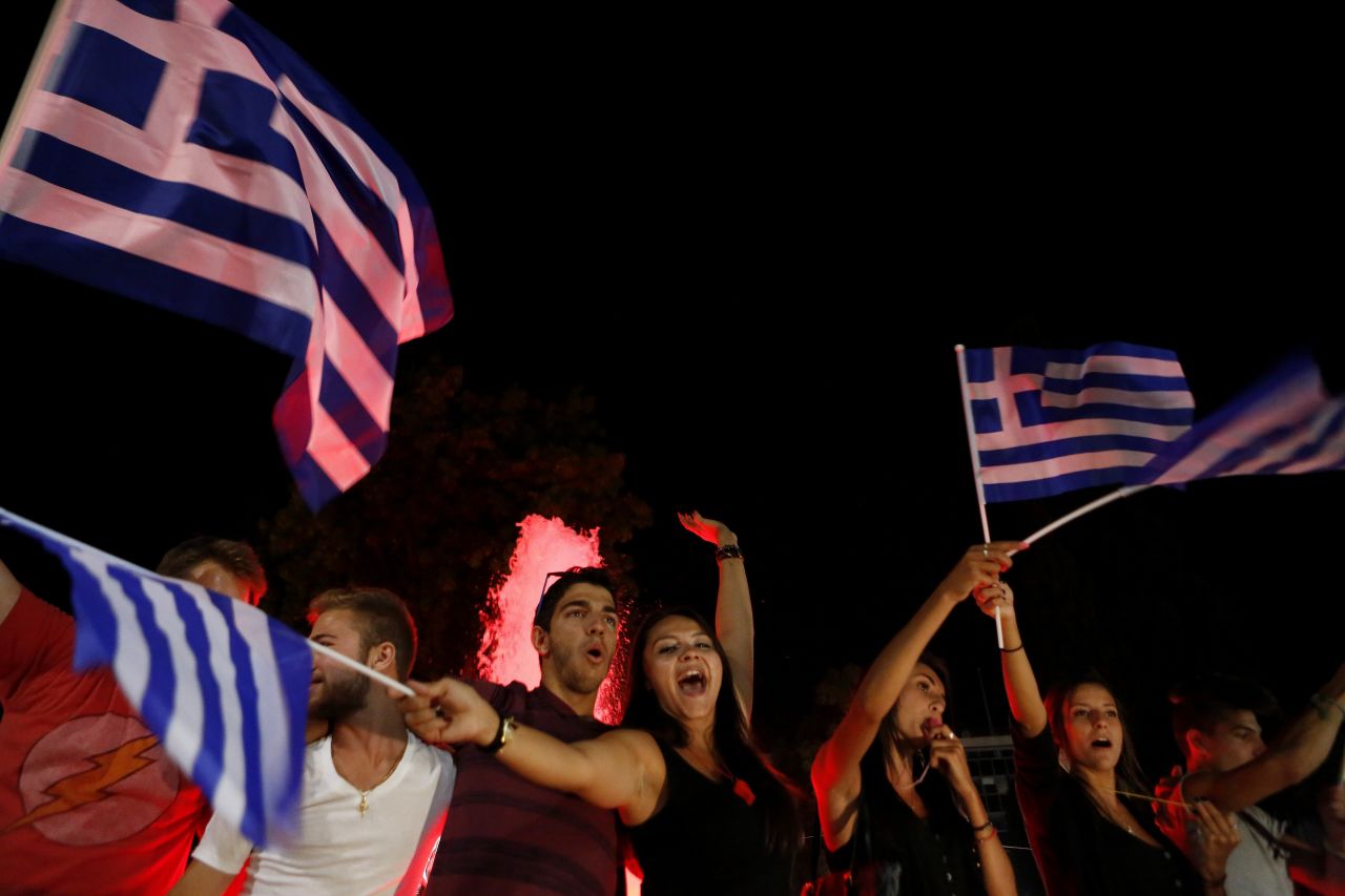 People wave Greek flags and shout slogans as they celebrate after the results of the referendum in Synatagma Square in central Athens on Sunday, July 5.