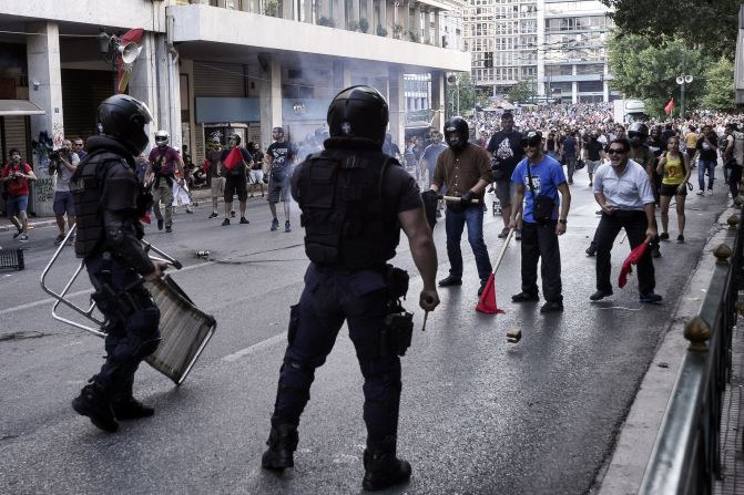 Anti-austerity demonstrators tussle with police. 