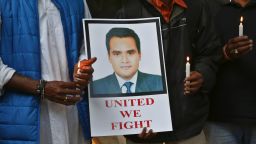 Indian journalists hold candles and a photograph of Akshay Singh during a memorial meeting in Bangalore, India, Monday, July 6, 2015. Singh, an Indian television journalist died under mysterious circumstances Saturday while on assignment covering allegations of a massive scheme to manipulate the results of entrance examinations for government jobs and medical colleges in the central Indian state of Madhya Pradesh. The alleged scam labeled "Vyapam" by Indian media after the Hindi name of the state's professional examination board since the story first surfaced in 2013. (AP Photo/Aijaz Rahi)