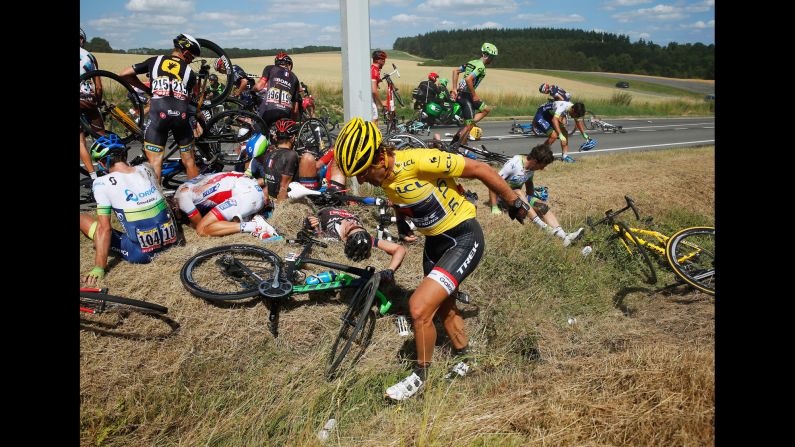 Cyclists recover on the ground after <a href="index.php?page=&url=http%3A%2F%2Fbleacherreport.com%2Farticles%2F2515851-huge-crash-takes-out-riders-on-stage-3-of-the-tour-de-france%3Futm_source%3Dcnn.com%26utm_medium%3Dreferral%26utm_campaign%3Deditorial" target="_blank" target="_blank">a massive crash</a> in the third stage of the Tour de France on Monday, July 6. The man in the foreground, Swiss cyclist Fabian Cancellara, was leading the race, but he had to withdraw after suffering two fractured vertebrae.