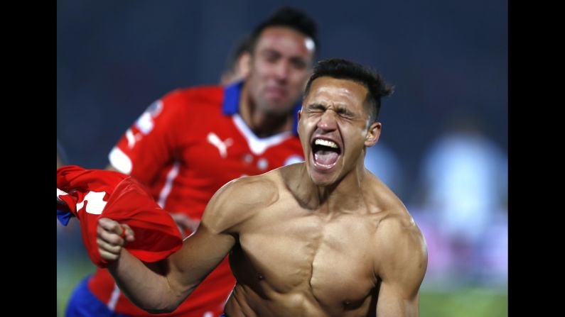 A shirtless Alexis Sanchez celebrates Saturday, July 4, after he scored the winning penalty kick for Chile in <a href="index.php?page=&url=http%3A%2F%2Fwww.cnn.com%2F2015%2F07%2F04%2Ffootball%2Ffootball-copa-argentina-chile%2F" target="_blank">the final of the Copa America soccer tournament.</a> The match against Argentina went to a shootout after ending 0-0 in extra time. It is the first Copa America title for Chile, who hosted this year's tournament. 