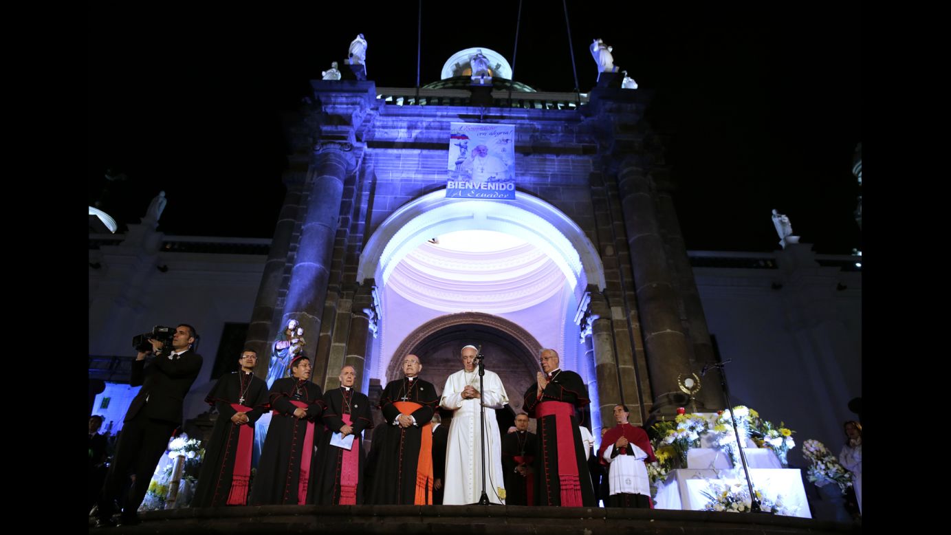 Pope Francis, center, prays outside the Cathedral of Quito on Monday, July 6.