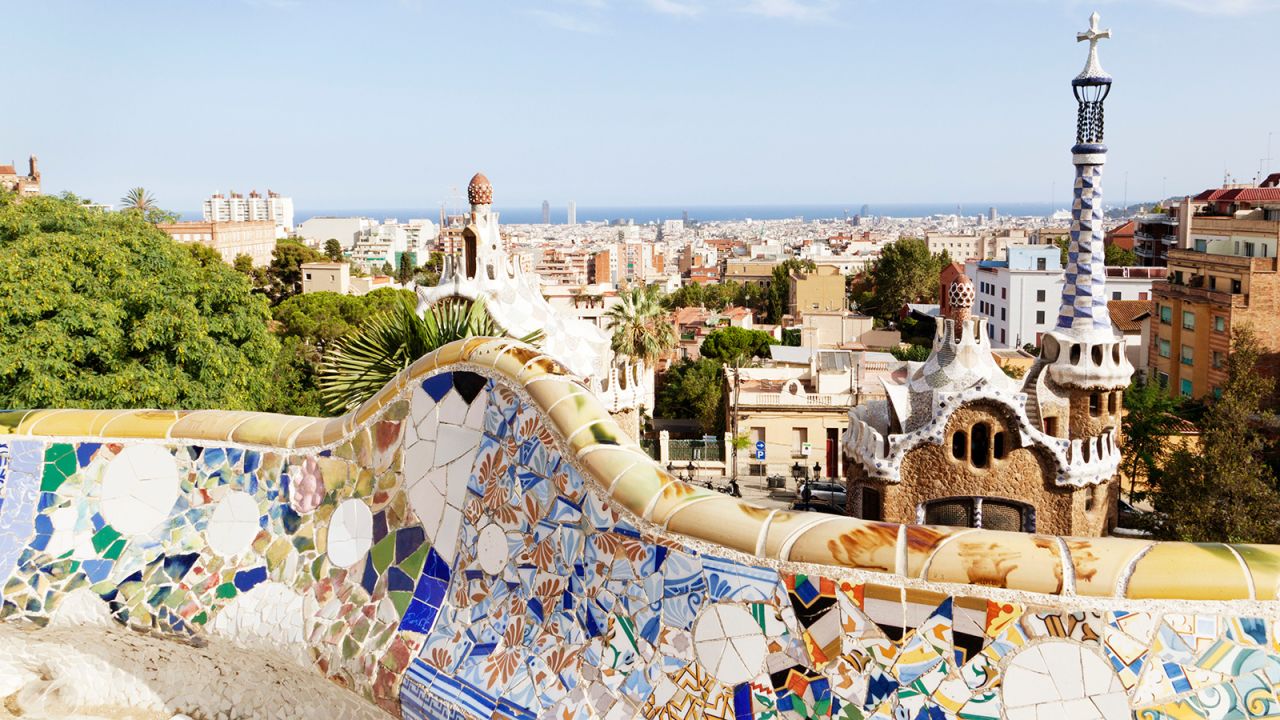 The beachside city of Barcelona, a favorite among global travelers, strikes a perfect balance between its iconic attractions, like the Antoni Gaudí-designed Parc Güell, seen here, and modern developments such as the zinc-and-glass design center DHUB. 
