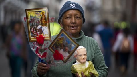 A woman in Quito, Ecuador, sells images and a bust of Pope Francis on Monday, July 6.