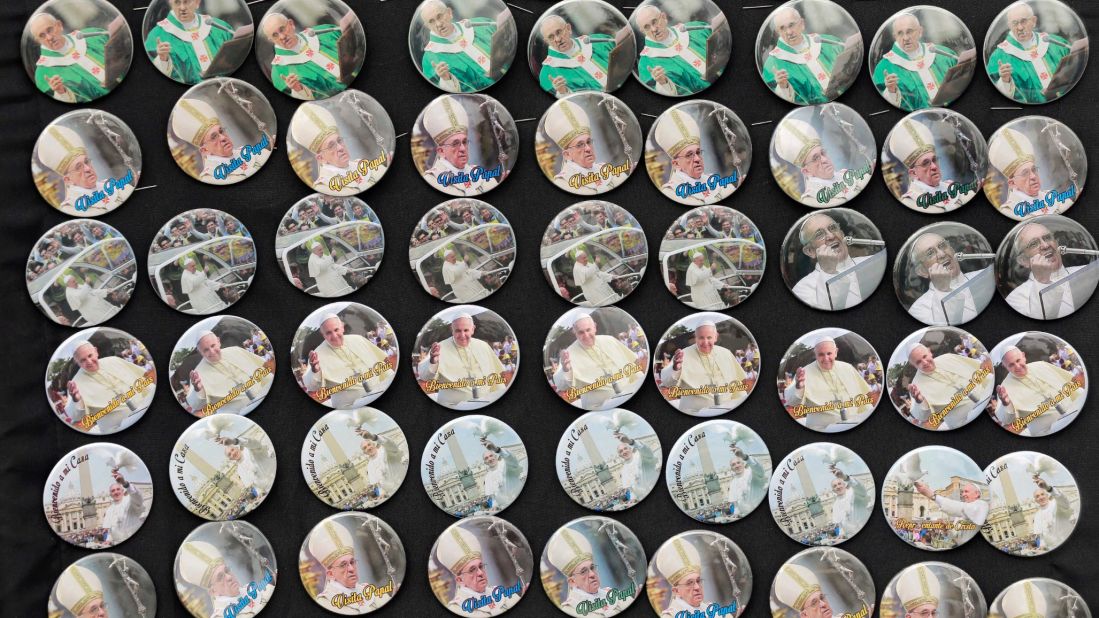 Pope buttons are sold at Samanes Park on July 5.