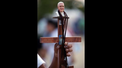 A street vendor sells a Pope Francis crucifix at Samanes Park on July 5.