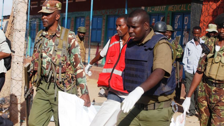 Kenya Police officers carry a body in Mandera, Kenya, Tuesday, July 7, 2015.