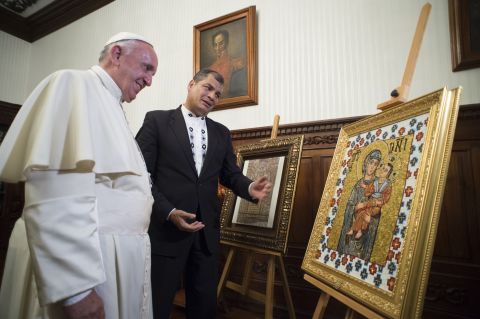 Pope Francis and Ecuadorian President Rafael Correa exchange gifts at the government palace in Quito on July 6.