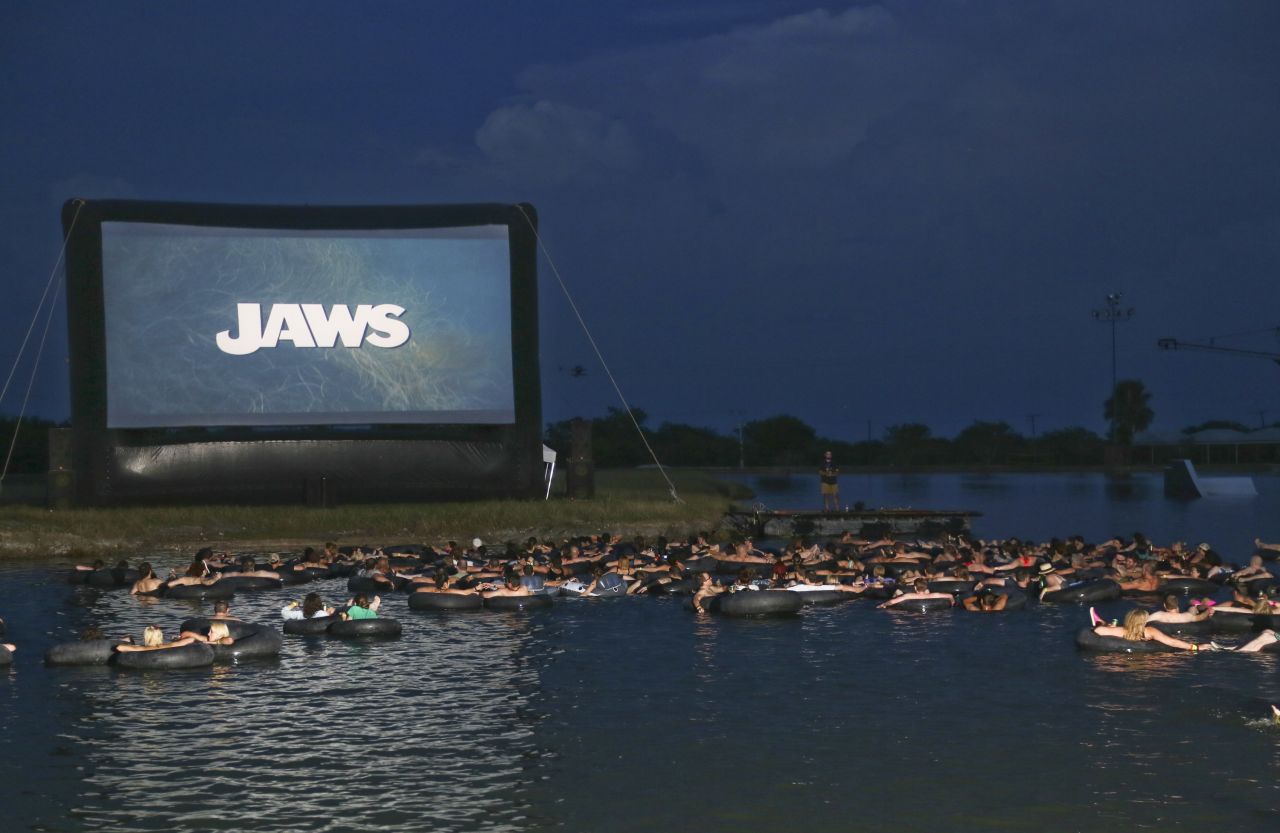The Alamo Drafthouse invites brave movie goers to view Steven Spielberg classic "Jaws," which turns 40 this year, on a giant screen as they float in inner tubes over murky waters.  