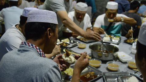 Men enjoy their Iftar meal at the mosque. 