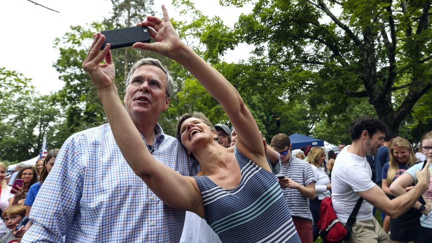 Republican presidential candidate former Florida Gov. Jeb Bush, left, has a selfie taken with a supporter while participating in the Fourth of July Parade festivities in Amherst, N.H.,,Saturday, July 4.