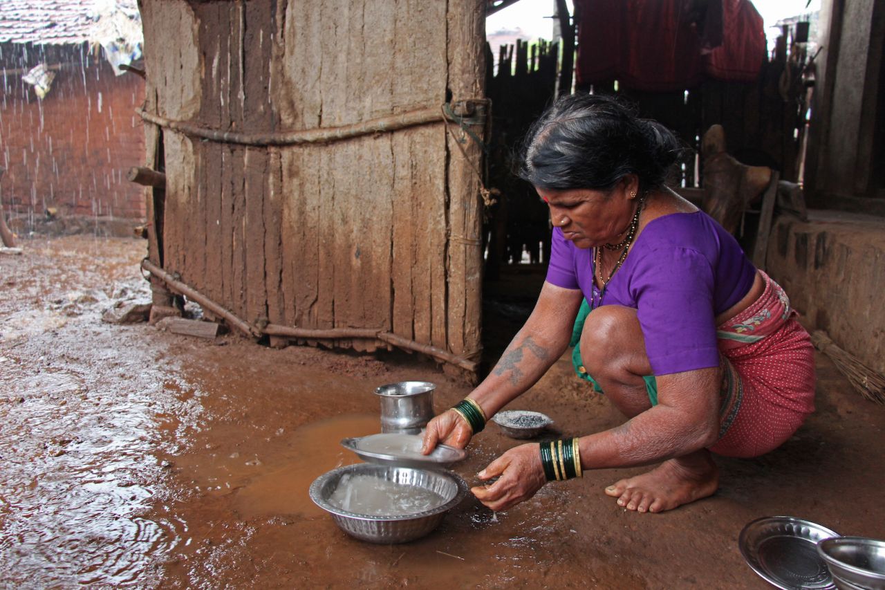 Tuki, the first wife, washes the utensils with rainwater. Tuki looks after the house while the other two wives are responsible for getting water.