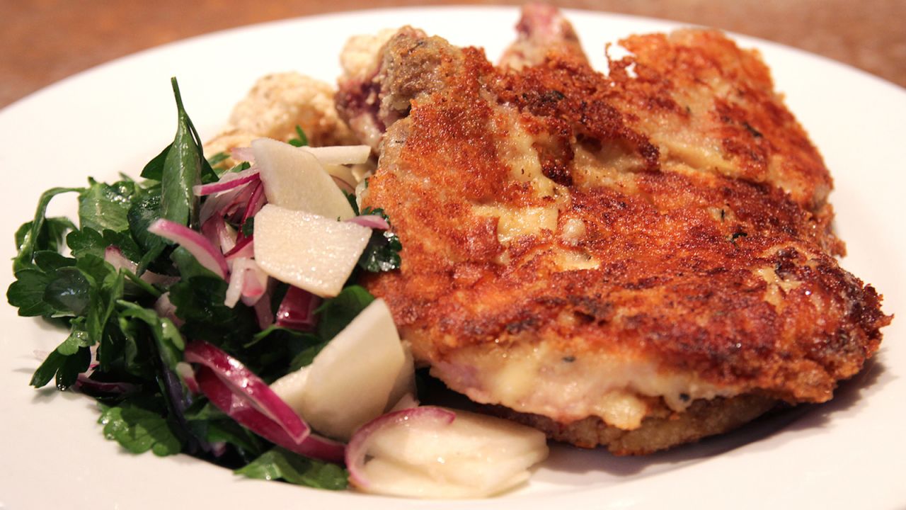 Milanesa is usually made from beef or chicken breast. The meat is hammered down to a thin cut before it's bathed in breadcrumbs then fried or baked. Toppings include a fried egg, cheese and tomato sauce or gruyère.