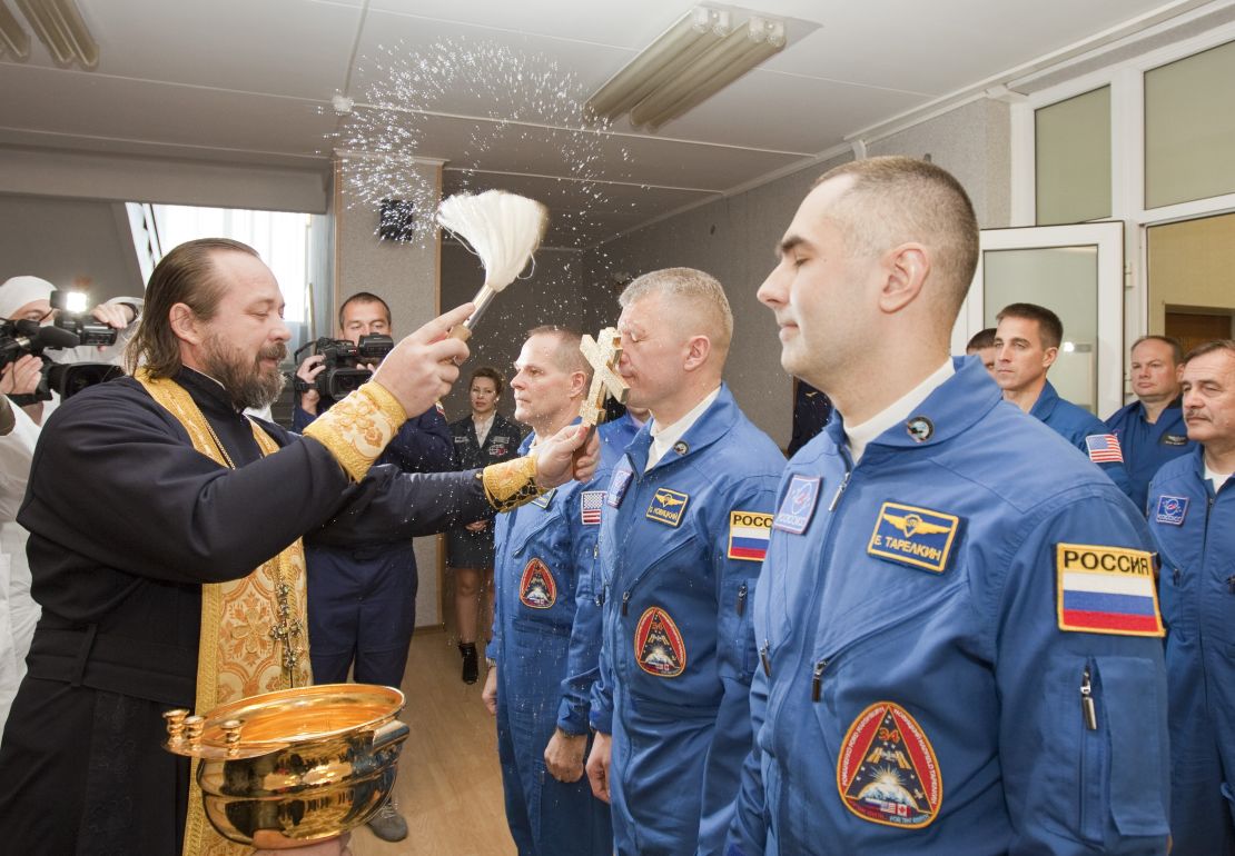 An Orthodox priest blesses the International Space Station crew members -- U.S astronaut Kevin Ford and Russian cosmonauts Oleg Novitskiy and Evgeny Tarelkin -- before launch.