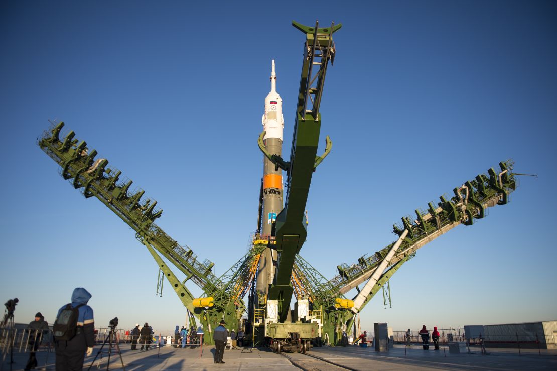 The gantry arms close around the Soyuz TMA-15M spacecraft to secure the rocket before launch.