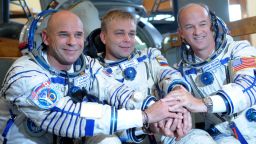 Canadian space tourist and founder of Cirque du Soleil Guy Laliberte (L), Russian cosmonaut Maxim Surayev (C) and US astronaut Jeff Williams (R) shake hands during a training session outside Moscow in Star City on September 9, 2009. The crew is set to travel from the Baikonur cosmodrome in a Russian Soyuz TMA-16 rocket to the international space station in late September. AFP PHOTO / DMITRY KOSTYUKOV (Photo credit should read DMITRY KOSTYUKOV/AFP/Getty Images)