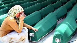 Caption:SREBRENICA, BOSNIA AND HERCEGOVINA: A Bosnian woman weeps next to the coffins of Muslim men and boys before their burial in Potocari, near Srebrenica, East Bosnia and Herzegovina, 11 July 2004. The recently identified remains of 338 Muslim men, aged from 15 to 70, were buried in a common funeral, marking the ninth anniversary of the massacre of Srebrenica, Europe's worst atrocity since World War II. More than 7,000 Muslim men and boys were separated from their women and killed by Serb forces in mass executions, following the Serb capture of the United Nations 'Safe Haven Zone' in Srebrenica in July 1995. Around 20,000 people attended the funeral. (Photo credit should read STRINGER/AFP/Getty Images