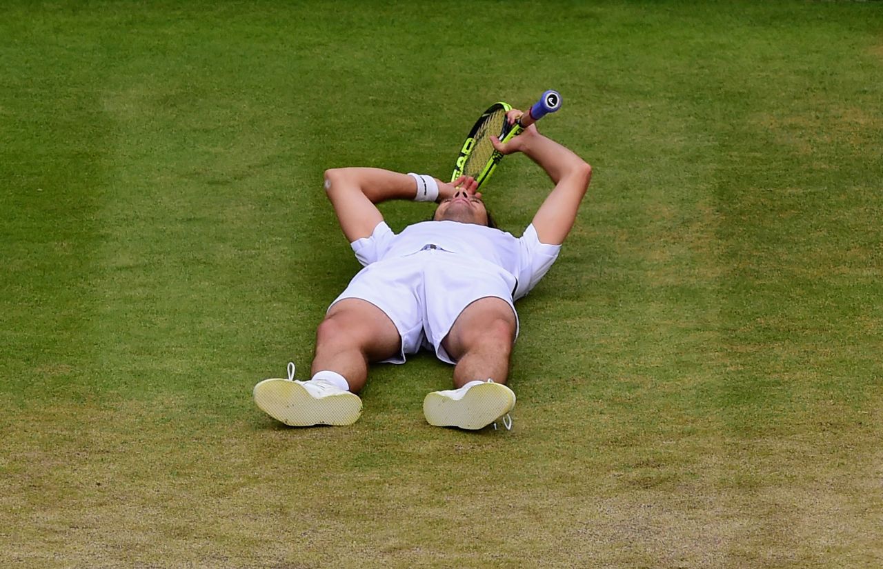 This was the moment of victory for Gasquet. He crumpled to the grass after Wawrinka's backhand went long. 