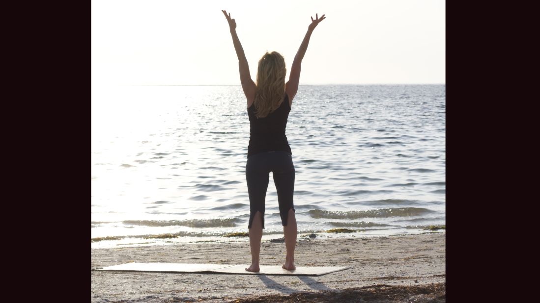 <strong>Pride pose:</strong> Stand facing the water with your feet hip distance apart. Raise both arms above your head in a triumphant "Y" position -- the same pose you'd take if you just won a race. Hold for three to five long, deep breaths. 