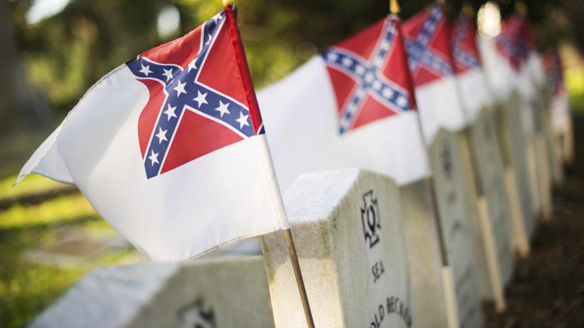 Caption:The second national flag of the Confederate States of America stands next to Confederate States of America (CSA) sailors at the Magnolia Cemetery in Charleston, South Carolina, June 26, 2015. President Barack Obama tackled the use of the confederate flag head-on, saying it was not just an emblem of heritage, but of racist subjugation. AFP PHOTO/JIM WATSON (Photo credit should read JIM WATSON/AFP/Getty Images)