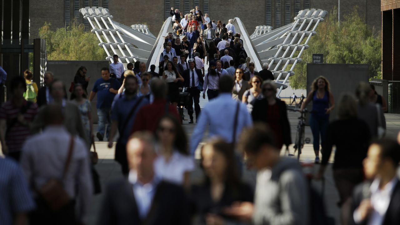 People walk across the Millennium Bridge in London on July 9. Some 4 million journeys are typically made on the Underground each day, so when the system is down, the city comes close to grinding to a halt.